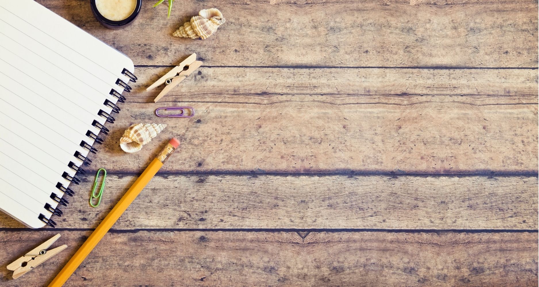 wood background with pencil and notebook for health coach program