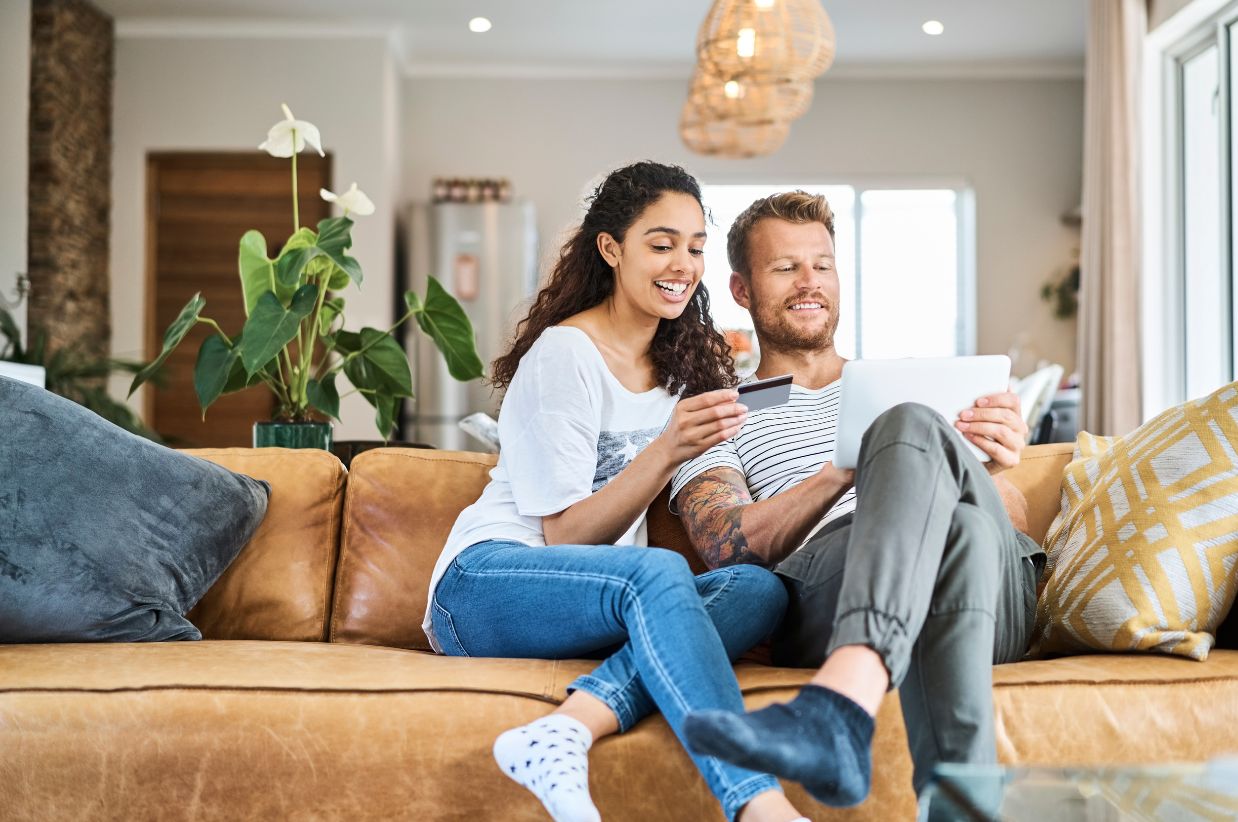 happy couple looking at ipad